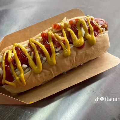 Hot dog topped with ketchup and mustard